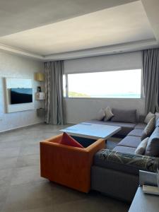 a living room with a couch and a table at Honor Appart Hotel in Fnidek