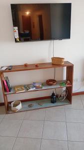 a wooden shelf with a mirror on a wall at Catalina in Viedma