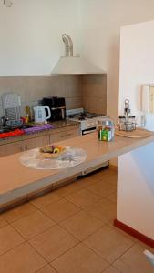a kitchen with a table with a counter top with a counter top at Catalina in Viedma