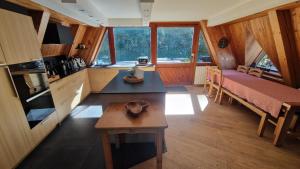 a kitchen with a bed and a table in a room at le chalet pointu de capucine in Bourg-Saint-Maurice