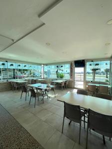 a restaurant with tables and chairs and windows at Marina Suite Otel in Silifke