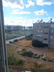 a view from a window of a building and a street at Obtsinsky Beach in Haifa