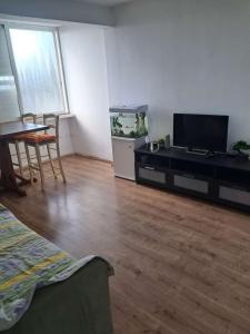 a living room with a fish tank and a table at Obtsinsky Beach in Haifa