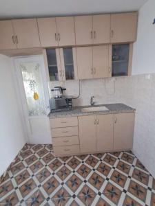 a kitchen with a sink and a tiled floor at Obtsinsky Beach in Haifa