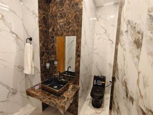 a bathroom with a sink and a mirror at Hotel DE Smart Multan in Multan +42 photos