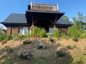 a house with a balcony on top of a hill at Królewska Sielanka in Mielnik