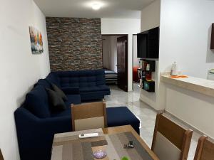 a living room with a blue couch and a table at Departamento Paty in Tampico