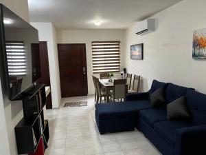 a living room with a blue couch and a table at Departamento Paty in Tampico