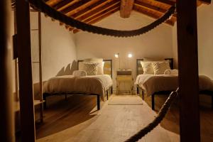 a room with two beds and a rope bridge at Charming stone house in Eus - Vue sur les Montagnes & Confort 2025 in Eus
