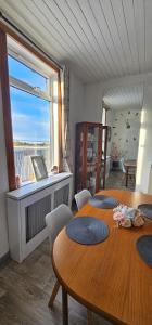a dining room with three tables and a large window at Westview in Buckie