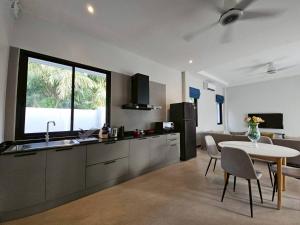 a kitchen and dining room with a table and a sink at The white mountain pool villa Ao Nang in Ban Thai Thai