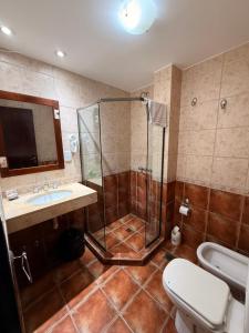 a bathroom with a shower and a toilet and a sink at Posada de Las Farolas in Salta