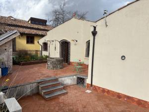 a house with a brick patio with a staircase at Soffio dell'Etna in Puntalazzo