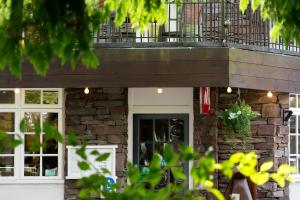a building with a balcony on top of it at Jacksons CafeBar & Guesthouse in Grasmere