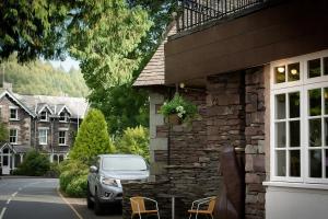 a car parked in front of a house with a car at Jacksons CafeBar & Guesthouse in Grasmere