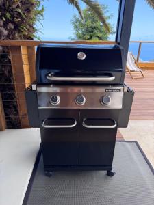 a grill sitting on top of a patio at Villa Ô in Les Avirons