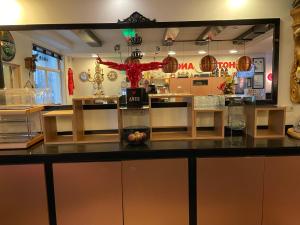 a counter in a store with a large mirror at Hotel Anco in Ons Belang