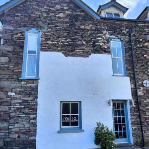 a white house with blue windows at Jacksons CafeBar & Guesthouse in Grasmere