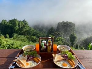 a tray with food and drinks on a table at Thammachart The Nature in Ban Kai Noi
