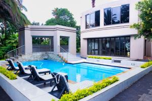 a house with a swimming pool in front of a house at The Hide on Aston-Sandton in Johannesburg