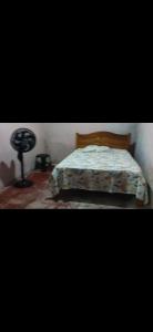 a bedroom with a bed and a lamp on the floor at AjuruLima in Bragança