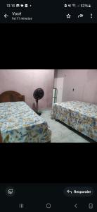 a picture of a bedroom with two beds at AjuruLima in Bragança