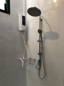 a shower with a shower head in a bathroom at Thammachart The Nature in Ban Kai Noi