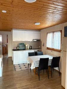a kitchen with a table and chairs in a room at Appartement Daria in Prémanon