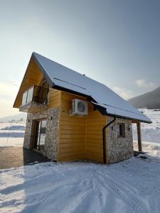 a log cabin with a roof in the snow at Marcinówka - Górski Domek w Gorcach in Tylmanowa +16 photos