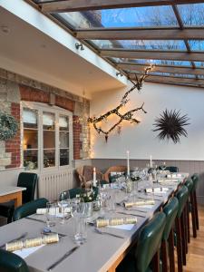 a long table in a room with green chairs at The Dove in Knook