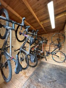 two bikes hanging on a wall in a garage at The Dove in Knook
