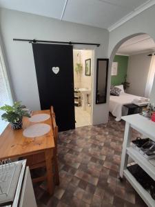 a room with a table and a room with a bed at @Echeveria in Montagu