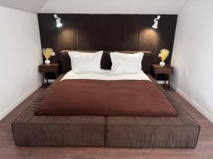 a large bed in a room with two tables at Boutique apartment Sky Nest in Uman