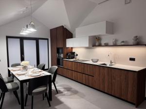 a kitchen and dining room with a table and chairs at Boutique apartment Sky Nest in Uman