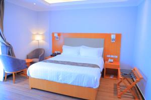 a bedroom with a bed and a desk and a chair at Libanos Hotel in Mekʼelē