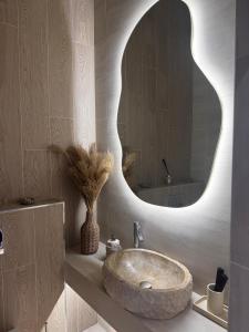 a bathroom with a sink and a large mirror at Boutique apartment Sky Nest in Uman +33 photos