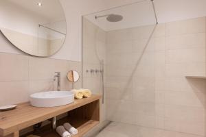 a bathroom with a sink and a shower at Pension Kleon in Rifiano +33 photos