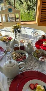a table with plates of food and a tea pot at Tidal Retreat in Plettenberg Bay +39 photos