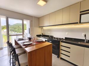 a kitchen with a island with a counter top at bauer in Camboriú
