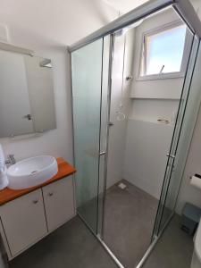 a bathroom with a shower and a sink at bauer in Camboriú +3 photos