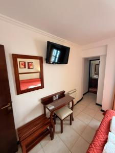 a living room with a table and a mirror at Posada de Las Farolas in Salta +16 photos