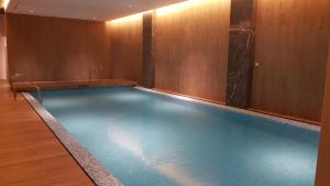 a large swimming pool in a hotel room at 2br Luxury apartment in Jakarta