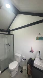 a bathroom with a toilet and a sink at Tiny House Socorro in Socorro