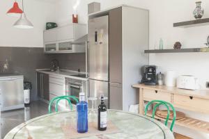 a kitchen with a glass table with bottles on it at La 68 in Santa Brígida +16 photos