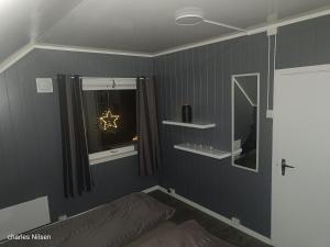 a bedroom with a bed and a window at Charles Country House in Solstad +74 photos