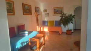 a living room with two beds and a table at Oasi Panoramica Suite in Lecco