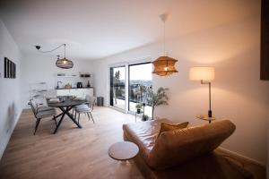 a living room with a couch and a table at Penthouse & Forest Retreat - near city in Bornheim