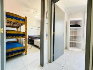 a room with two bunk beds and a hallway at Ap Aconchego 210 B in Ubatuba