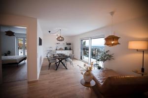 a living room with a couch and a dining room at Penthouse & Forest Retreat - near city in Bornheim