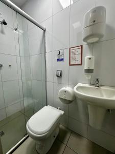 a bathroom with a toilet and a sink at Hostel Salazar in Campo Grande